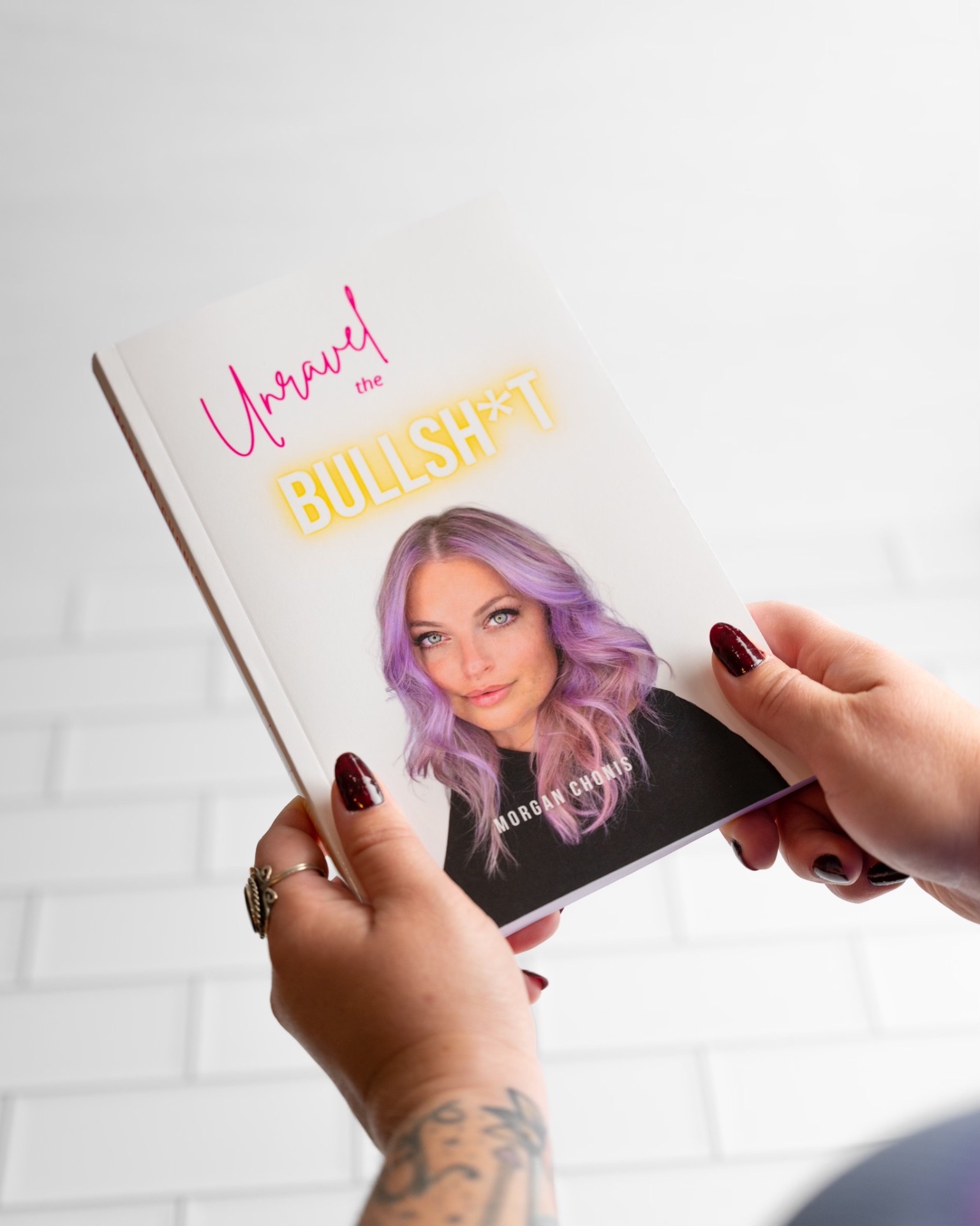 Unravel the Bullsh*t paperback held in hands